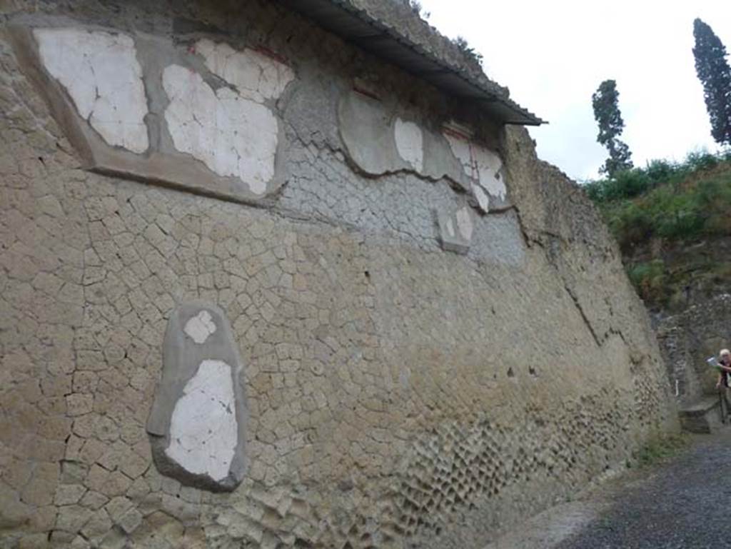 Ins. Orientalis II 4, Herculaneum, September 2015. North wall of large entrance hall.
According to Deiss, this room would have had a black tessellated pavement with portions set in marble, white walls relieved by architectural motifs, and a decorated vaulted ceiling. The ceiling collapsed when the volcanic debris was removed, due to the Bourbon tunnellers criss-crossing the walls and vault so many times. Portions of the vault revealed that the eight-rayed stars in wine-red, olive green, and chrome yellow were painted on a background of pale blue.
See Deiss, J.J. (1968). Herculaneum: a city returns to the sun. U.K, London, The History Book Club, (p.123-4).